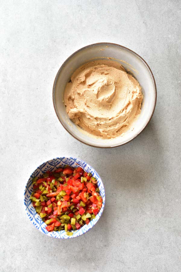 a bowl with basic version of Liptauer and another bowl with garnish