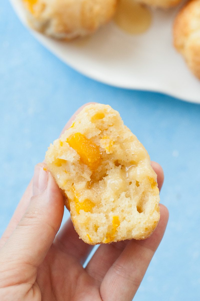 close up shot on a mango muffin with passion fruit glaze cut in half