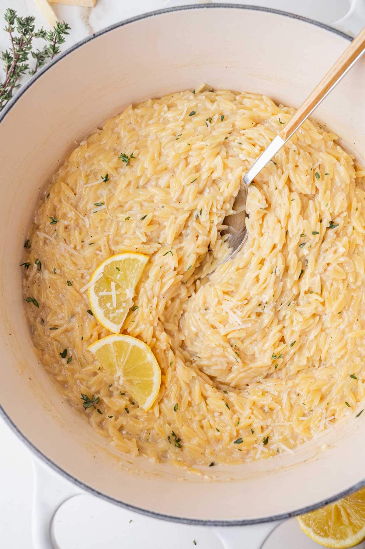 Lemon parmesan orzo in a white pot.
